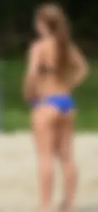 Cute girl playing volleyball in her little bikini