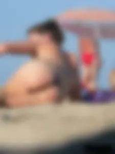 Sexy babe with a nice body topless and in a thong on the beach