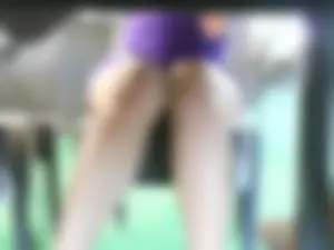 Girl in a short dress flashing her panties under the table