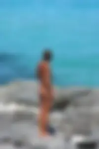 Older lady on a nude beach showing her body
