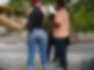 Red haired lady with a nice ass in tight jeans waiting for the bus