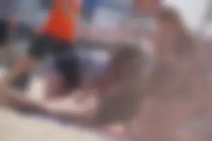 A group of teens in bikinis on the beach