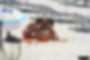 Topless milf and her topless daughter on the beach