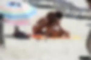 Topless milf and her topless daughter on the beach