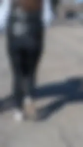 A beautiful little brunette walking in the park. tight black leggings