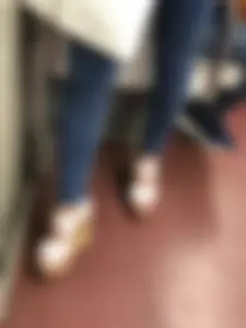 Candid girl wearing tight blue jeans and sandals on high platforms