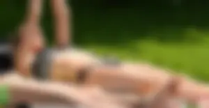 Couple sexy girls in bikinis getting sun at the lake