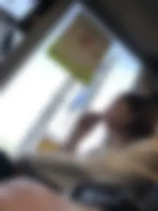 Crossed legs in black pantyhose closeup in a public bus