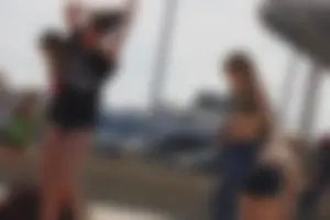 A group of teens in bikinis on the beach
