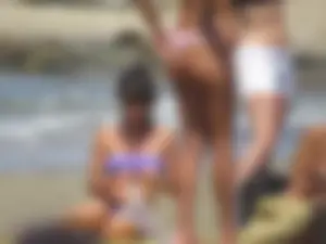 Girl with a great ass in thong bikini on the beach