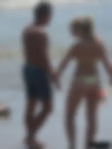 Sexy blonde on the beach in a yellow thong bikini