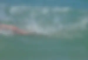 Milf at the beach in the water with hard nipples and a nice body