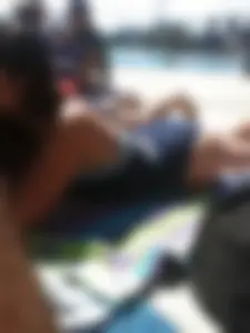 Sexy brunette teen in blue swimsuit by the pool