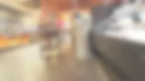 Blond milf shopping for groceries shows a hint of cheeks