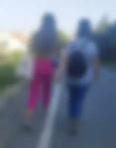 Two candid hotties walking down the suburban street