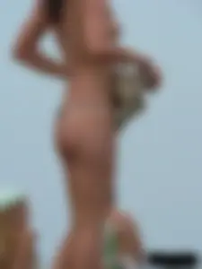Sexy babe with a nice body topless and in a thong on the beach