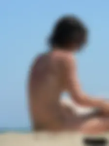 Topless beach milf looking sexy in a tiny g-string bikini