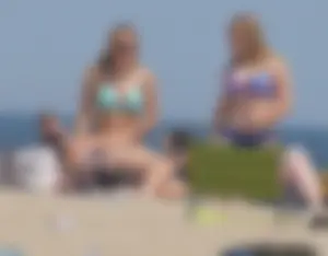 3 girls on the beach in bikinis with big boobs, one brunette and two blondes