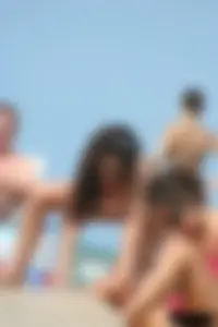 2 topless girls at the beach in thongs