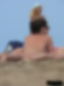 Sexy babe with a nice body topless and in a thong on the beach