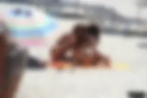 Topless milf and her topless daughter on the beach