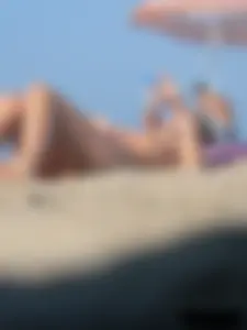 Sexy babe with a nice body topless and in a thong on the beach