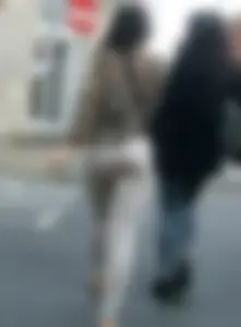 Brunette lady with a nice ass in light grey leggings walking