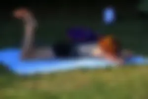 Skinny Barefoot Redhead Lying on the Grass in the Park