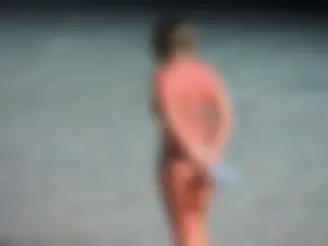 Blonde milf on the beach in her bikini