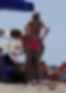 Sexy and skinny girl on the beach in pink bikini