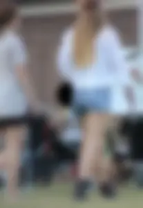 Hippie type dressed girl in denim shorts with a nice ass
