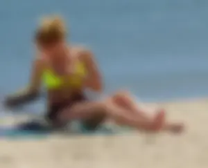 Sexy ass blonde milf on the beach in a thong with cameltoe and bending over