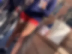 Bunch of girls in various outfits at a Cardinals baseball game