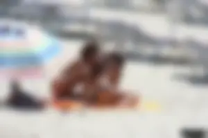 Topless milf and her topless daughter on the beach