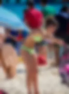 A few sexy girls with great asses in thong bikinis at the beach