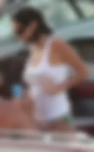 Bikini babe on a boat with a wet see through white shirt showing her tits