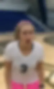 Bunch of cute college girls in bright pink shorts playing volleyball