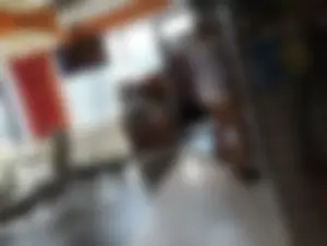 Girl in Mini Shorts and Sandals in a Cafe Candid