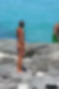 Older lady on a nude beach showing her body