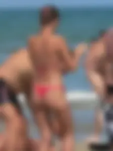 A bunch of hot babes on the beach in thong bikinis