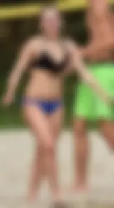 Cute girl playing volleyball in her little bikini
