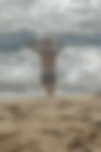 Blonde lady on the beach in bikini top and spandex shorts with a nice gap