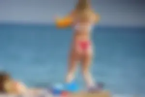 Hot blonde with a slammin body in red thong bikini on the beach