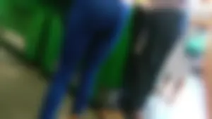Young ebony girl in blue leggings with vpl while shopping