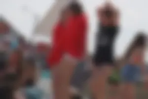 A group of teens in bikinis on the beach