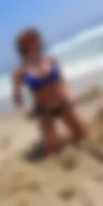 Girl with great tits playing in the sand at the beach