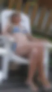 Skinny Girl in Swimsuit Sitting with Legs Crossed
