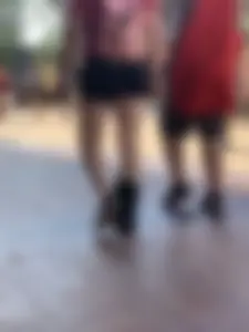 Bunch of girls in various outfits at a Cardinals baseball game