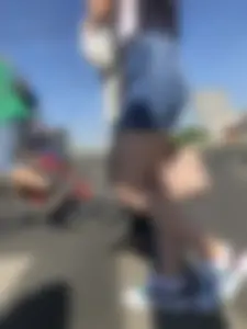 Cute Girl in a Short Denim Skirt Walking on a Street And Waiting on a Crosswalk Gallery