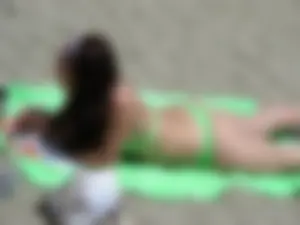 Sexy girl on the beach in her green thong bikini